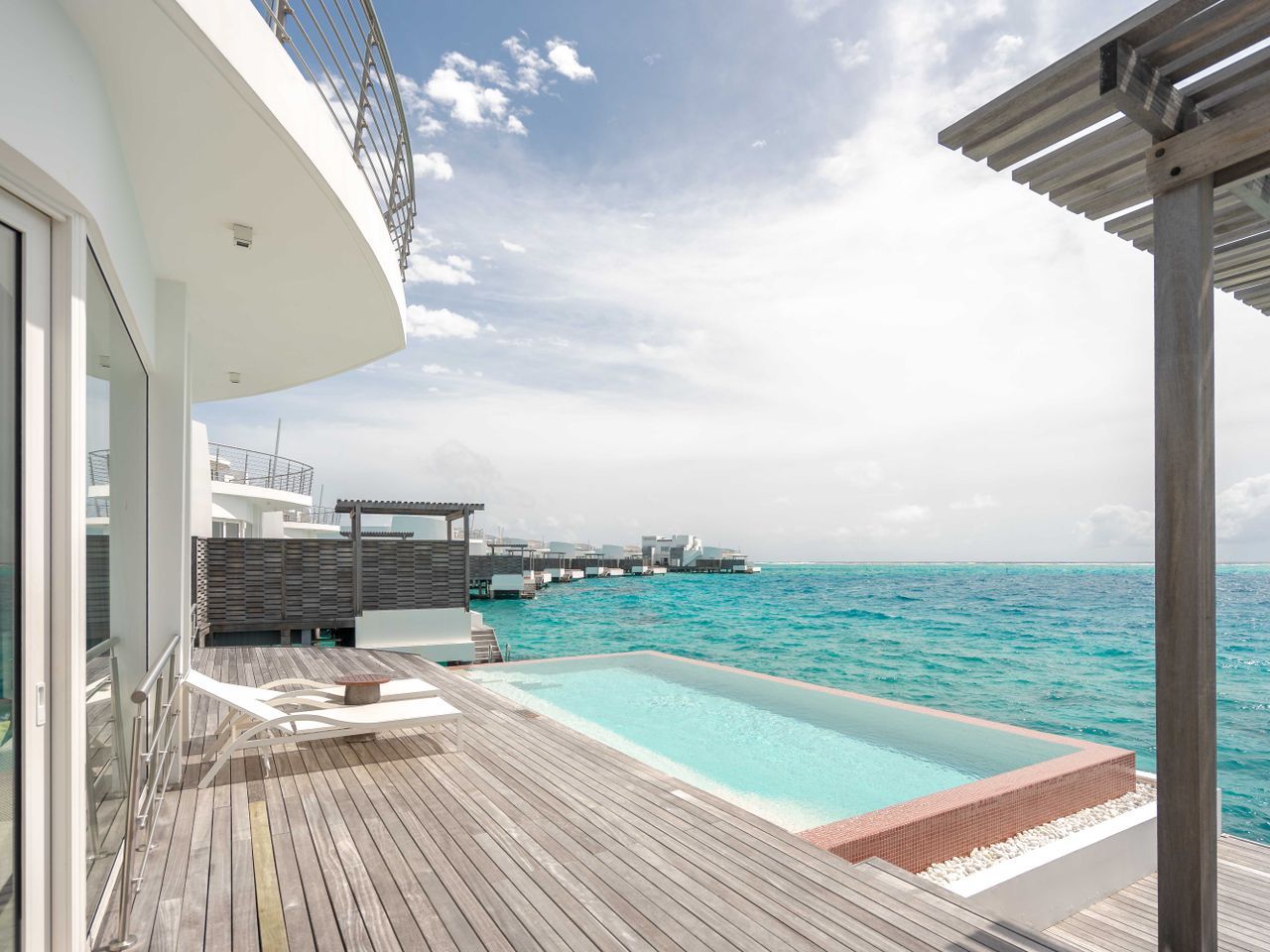 A pool deck opening straight onto the sea