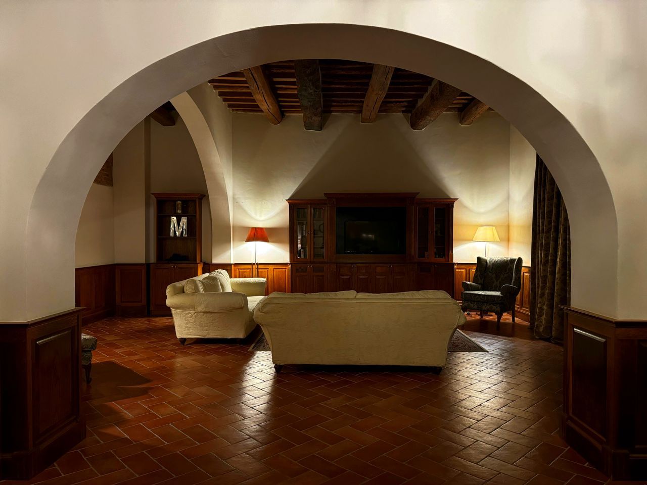 An arched stone lounge with soft daylight