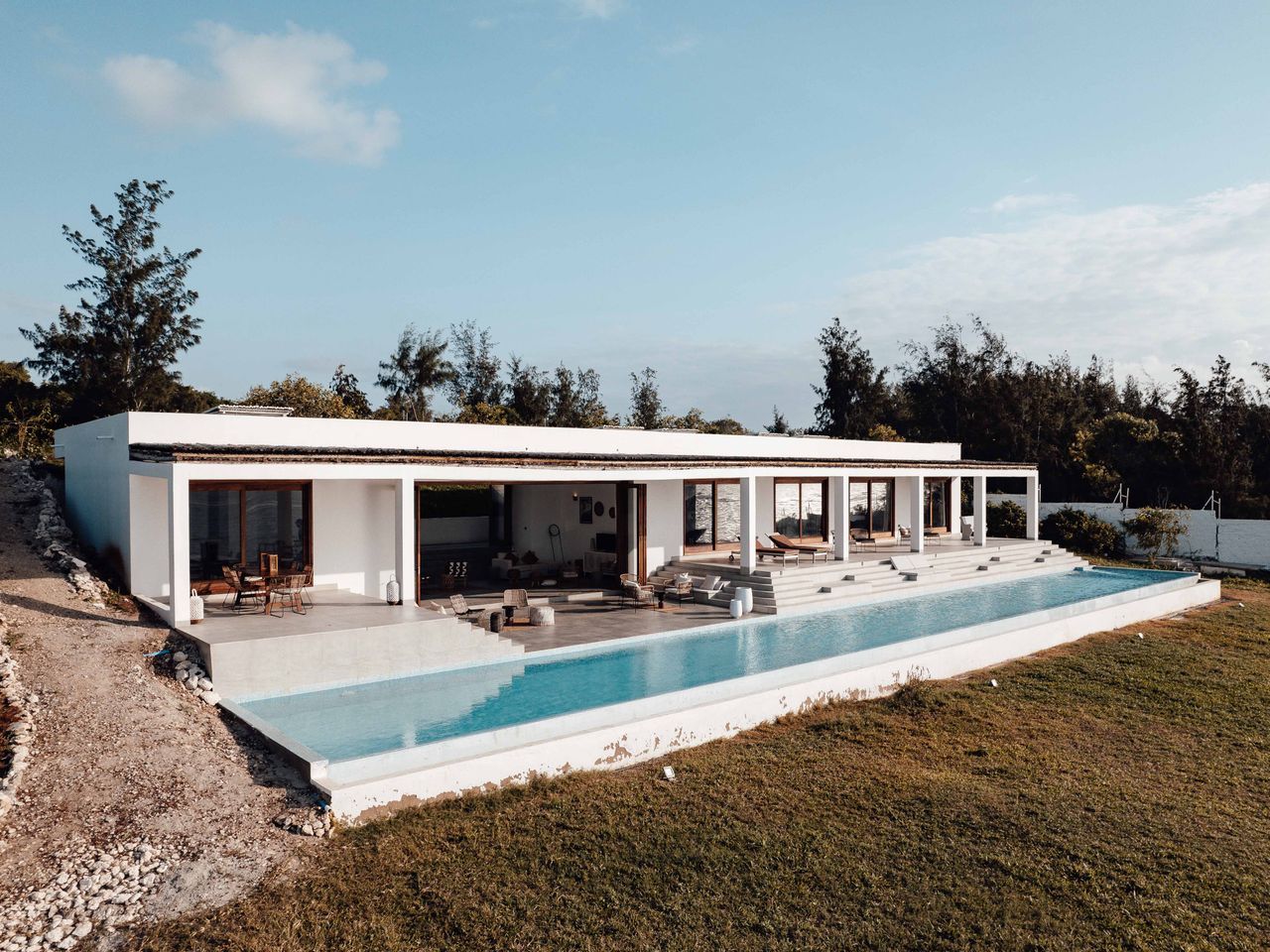 A white modern villa above an infinity pool